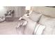 Comfortable bedroom with a plush bed, decorative pillows, and cozy armchair at 416 Calabria Ave, Davenport, FL 33897