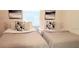 Inviting bedroom with two twin beds and neutral decor, offering a comfortable and relaxing space at 416 Calabria Ave, Davenport, FL 33897