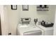 Convenient laundry room with a washer, dryer, overhead storage, and essential supplies at 416 Calabria Ave, Davenport, FL 33897