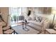 Bright living room with sliding glass doors leading to a patio, complemented by stylish furniture and decor at 416 Calabria Ave, Davenport, FL 33897