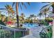 Beautiful pool area featuring palm trees, lounge chairs, and lush landscaping at 416 Calabria Ave, Davenport, FL 33897