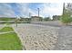 Sandy volleyball court on a sunny day, surrounded by greenery and buildings at 416 Calabria Ave, Davenport, FL 33897