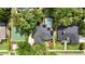 An aerial view highlights a private basketball court, pool, and well-maintained homes surrounded by lush landscaping at 4411 Little Water St, Orlando, FL 32817