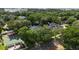The aerial image shows a green residential neighborhood, several homes, mature trees, and a full basketball court at 4411 Little Water St, Orlando, FL 32817