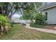 Charming backyard featuring a brick path, manicured landscaping, and a private fence at 4411 Little Water St, Orlando, FL 32817