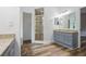 Bathroom with granite countertops, a glass-enclosed shower, and wood look flooring at 4411 Little Water St, Orlando, FL 32817