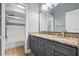 Bathroom boasts double sinks with granite countertop, a full mirror, and a tub with shower at 4411 Little Water St, Orlando, FL 32817