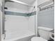 Bright bathroom featuring a tub with white tile surround and glass shelving at 4411 Little Water St, Orlando, FL 32817