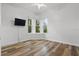 Bedroom with wood floors, ceiling fan, and large windows with bright natural light at 4411 Little Water St, Orlando, FL 32817