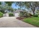 View of the house showing the driveway, garage, and well-maintained lawn with manicured shrubs at 4411 Little Water St, Orlando, FL 32817