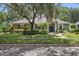Charming single-story home with manicured lawn, mature trees, and a welcoming front entrance at 4411 Little Water St, Orlando, FL 32817