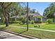 Single-story home featuring lush landscaping, trimmed lawn, and mature trees in a suburban setting at 4411 Little Water St, Orlando, FL 32817