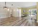 Spacious living room featuring modern light fixtures, an open layout, and beautiful flooring at 4411 Little Water St, Orlando, FL 32817