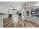 Open living area features a fireplace, ceiling fan, and sliding glass doors with views of the screened-in pool at 4411 Little Water St, Orlando, FL 32817