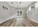 Bright main bedroom with wood floors, tray ceiling, and access to the pool and backyard at 4411 Little Water St, Orlando, FL 32817