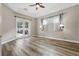 Spacious main bedroom features wood floors, ceiling fan, and access to the pool and backyard at 4411 Little Water St, Orlando, FL 32817