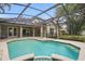 A private screened pool with spa offers a tranquil outdoor retreat and entertainment space at 4411 Little Water St, Orlando, FL 32817