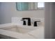 Close-up of a modern black faucet and marble countertop in a stylish bathroom at 4837 Lorraine Way, Orlando, FL 32812