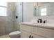 Modern bathroom features new vanity with stone countertop and tiled shower at 4837 Lorraine Way, Orlando, FL 32812