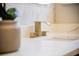 Modern gold bathroom faucet on a white countertop with clean, square lines at 4837 Lorraine Way, Orlando, FL 32812