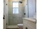 Stylish bathroom with a tiled walk-in shower, modern fixtures and a white vanity at 4837 Lorraine Way, Orlando, FL 32812