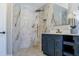 Modern bathroom with marble wall tiles, gold fixtures, and a sleek vanity at 4837 Lorraine Way, Orlando, FL 32812