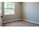 Empty bedroom features wood laminate flooring and bright window with outdoor view at 4837 Lorraine Way, Orlando, FL 32812
