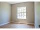 A simple bedroom with light wood floors and a bright window at 4837 Lorraine Way, Orlando, FL 32812