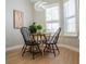 Cozy dining area with modern light fixture, table, and four chairs at 4837 Lorraine Way, Orlando, FL 32812