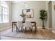 Chic dining room with modern lighting, stylish artwork, and a jute rug over wood flooring at 4837 Lorraine Way, Orlando, FL 32812