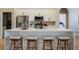 Bright kitchen island featuring white quartz countertop, modern cabinets and bar seating at 4837 Lorraine Way, Orlando, FL 32812