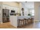 Spacious kitchen with quartz island, modern appliances, white cabinetry and bar stools at 4837 Lorraine Way, Orlando, FL 32812