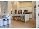 Open-concept kitchen with a large white island, and stainless steel appliances, flowing into the living room at 4837 Lorraine Way, Orlando, FL 32812