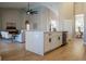 Spacious kitchen island featuring quartz countertops, an undermount sink, and seating, flows into the living area at 4837 Lorraine Way, Orlando, FL 32812