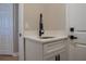 Laundry room featuring a sleek quartz countertop and modern black hardware at 4837 Lorraine Way, Orlando, FL 32812