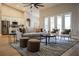 Bright living room with a cozy seating area, and white french doors, flowing to the kitchen at 4837 Lorraine Way, Orlando, FL 32812