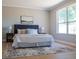 Comfortable main bedroom featuring a king bed with tufted headboard and a decorative rug at 4837 Lorraine Way, Orlando, FL 32812