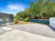 Home's backyard features a screened-in pool with stone pavers and surrounding trees at 4993 Heatherstone Pl, Orlando, FL 32812