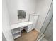 Bathroom area features vanity, shelving, and storage space next to the glass shower at 4993 Heatherstone Pl, Orlando, FL 32812
