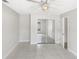 This bedroom features tile floors, mirrored closet doors, and an overhead ceiling fan at 4993 Heatherstone Pl, Orlando, FL 32812