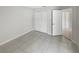 An empty bedroom with tile floors and a spacious closet, ready for personalization at 4993 Heatherstone Pl, Orlando, FL 32812
