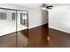 Spacious bedroom with dark wood floors, offers ample natural light and mirrored closet doors at 4993 Heatherstone Pl, Orlando, FL 32812