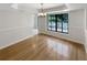 Bright dining room featuring a large window, hardwood floors, and modern lighting fixture at 4993 Heatherstone Pl, Orlando, FL 32812
