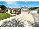 Charming single-story home with a well-manicured lawn, driveway, and two-car garage at 4993 Heatherstone Pl, Orlando, FL 32812