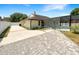 View of the home's backyard with a screened-in pool, patio, and driveway at 4993 Heatherstone Pl, Orlando, FL 32812