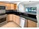 Kitchen featuring granite countertops, stainless steel appliances, and tile flooring at 4993 Heatherstone Pl, Orlando, FL 32812