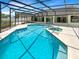 Enjoy a serene backyard with a sparkling pool, spa, and screened-in lanai, creating a perfect oasis at 4993 Heatherstone Pl, Orlando, FL 32812