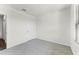 Bedroom with neutral carpet, door, and bright natural light at 5111 Marshelder St, Apopka, FL 32712