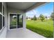 Covered patio overlooking a green lawn at 5111 Marshelder St, Apopka, FL 32712
