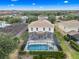 Aerial shot of home with screened-in pool, landscaping, and tile roof at 5156 Oakbourne Ave, Davenport, FL 33837